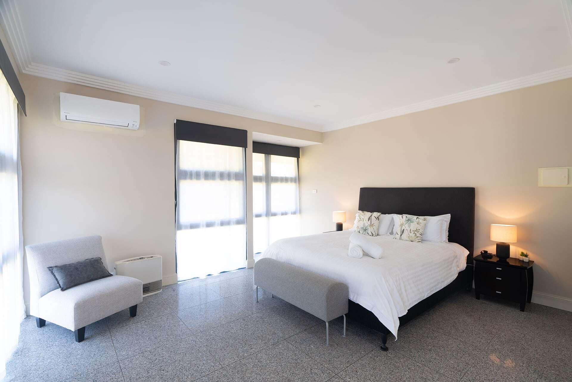 Home 2 Comfortable hotel room with king bed, soft lighting, and contemporary furnishings.