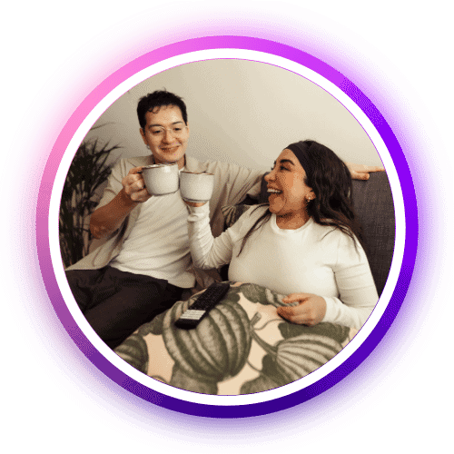 Colourful image of friends enjoying drinks on a cozy sofa, showcasing social and lifestyle moments.